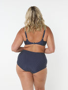 model showing back of navy and white dots high waisted swim pant