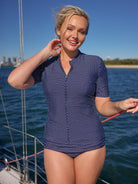 model wearing navy and white dots rash vest