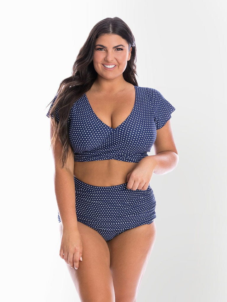 model wearing navy and white dots skirted pant with matching top