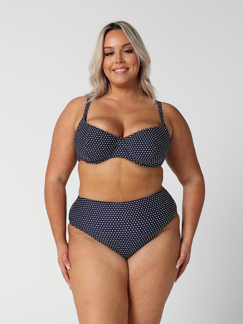 model wearing navy and white dots high rise bikini bottom with matching top