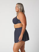 model wears navy polka dot skater skirt