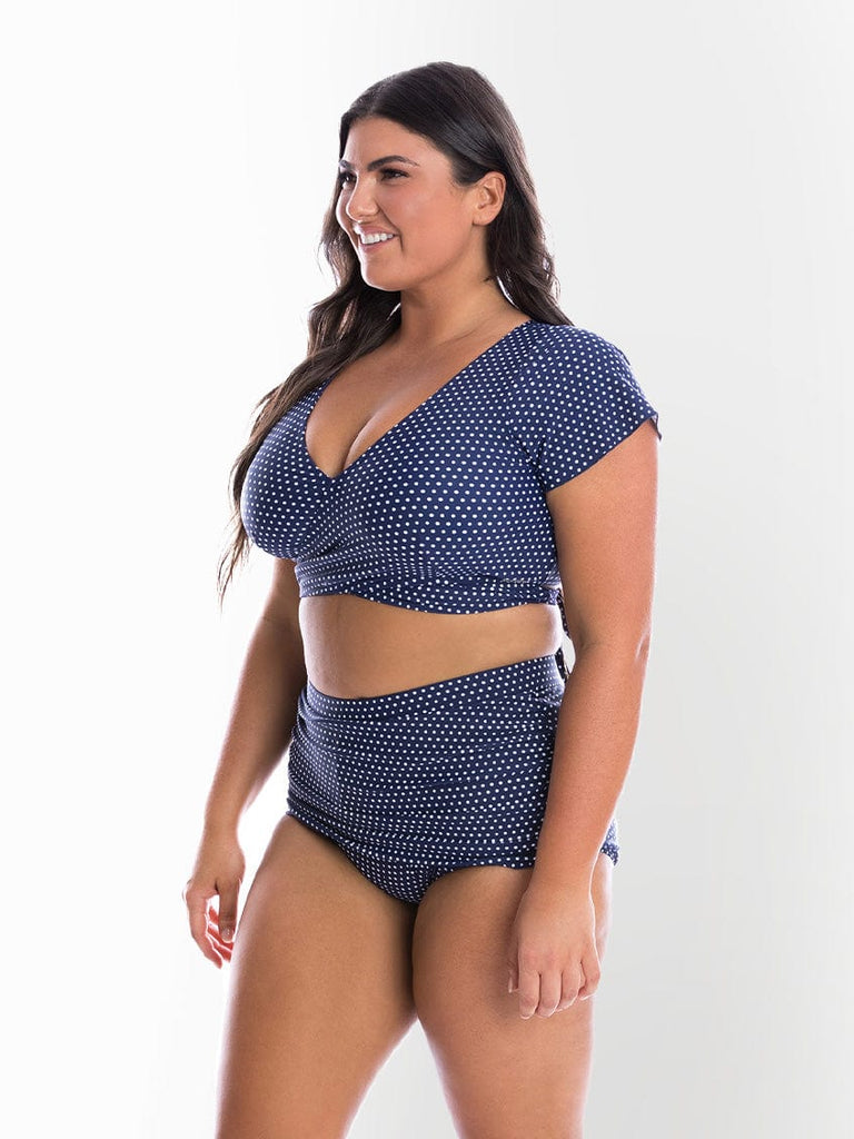 model showing side of ruched navy dots bikini bottom