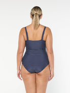 model showing back of navy and white dots women's one piece
