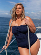 model wearing navy honey comb strapless swimsuit