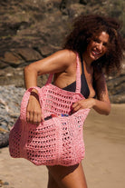 model opening pink woven bag