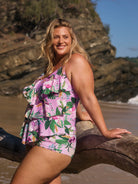 model wearing pink tropical print tankini