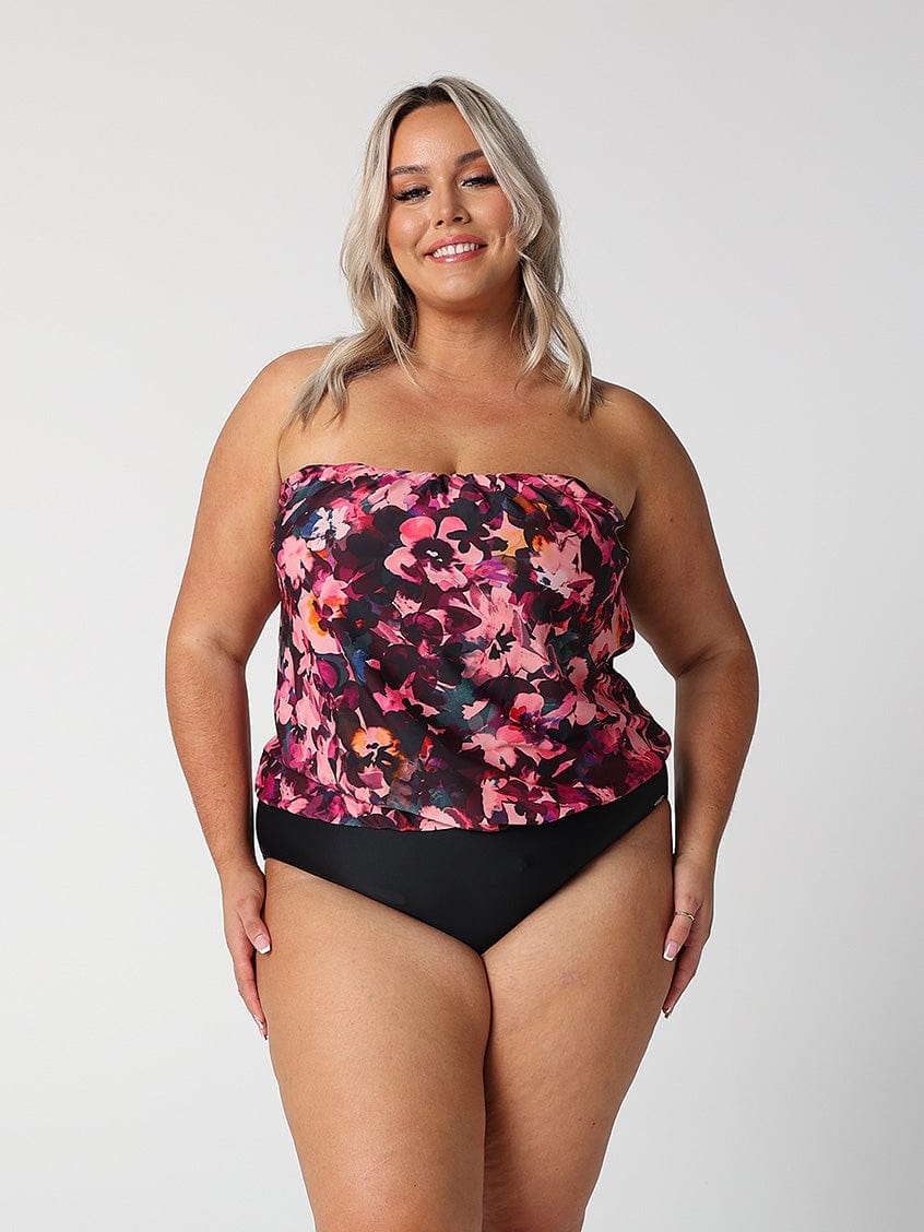 model wearing pink and plum coloured floral strapless swimsuit