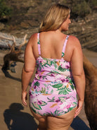 model wearing full coverage pink floral bottom with matching tankini at beach