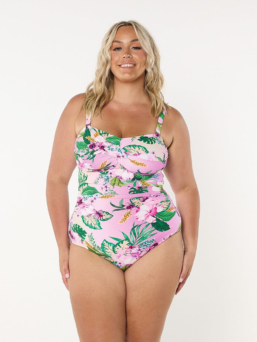 model wearing light pink floral women's swimsuit