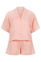 ghost mannequin of pale pink crepe cotton lounge wear set, short sleeve and button through with matching shorts