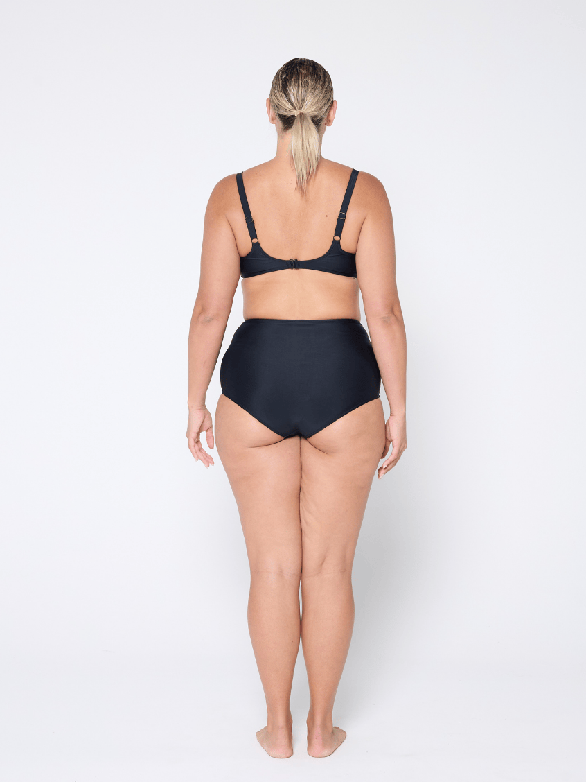 Person wearing a black bikini set on a white background