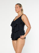 model showing side of black ruffle tankini top
