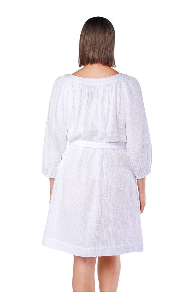 back of model wearing white cheesecloth knee length dress