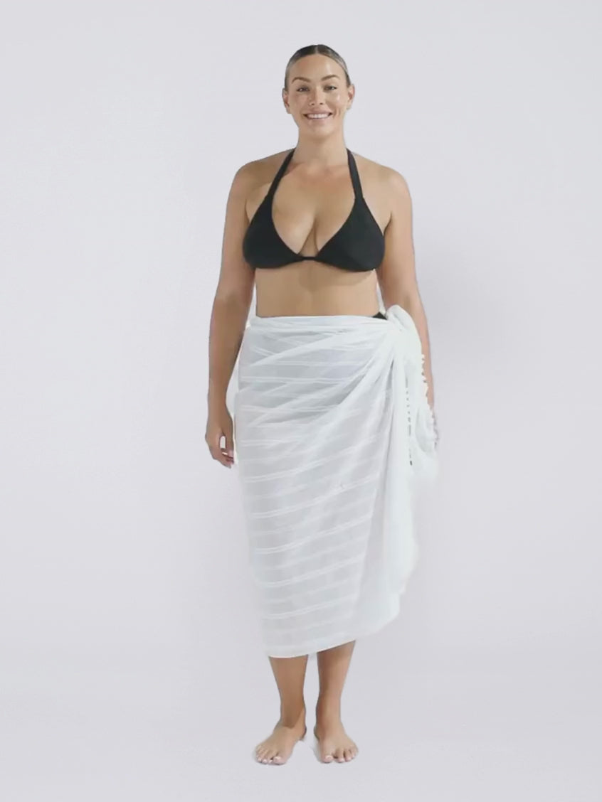 Blonde model in studio wearing a white cotton sarong in white