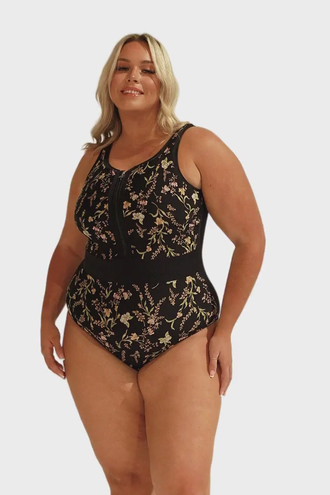 Model wearing black floral sleeveless one piece