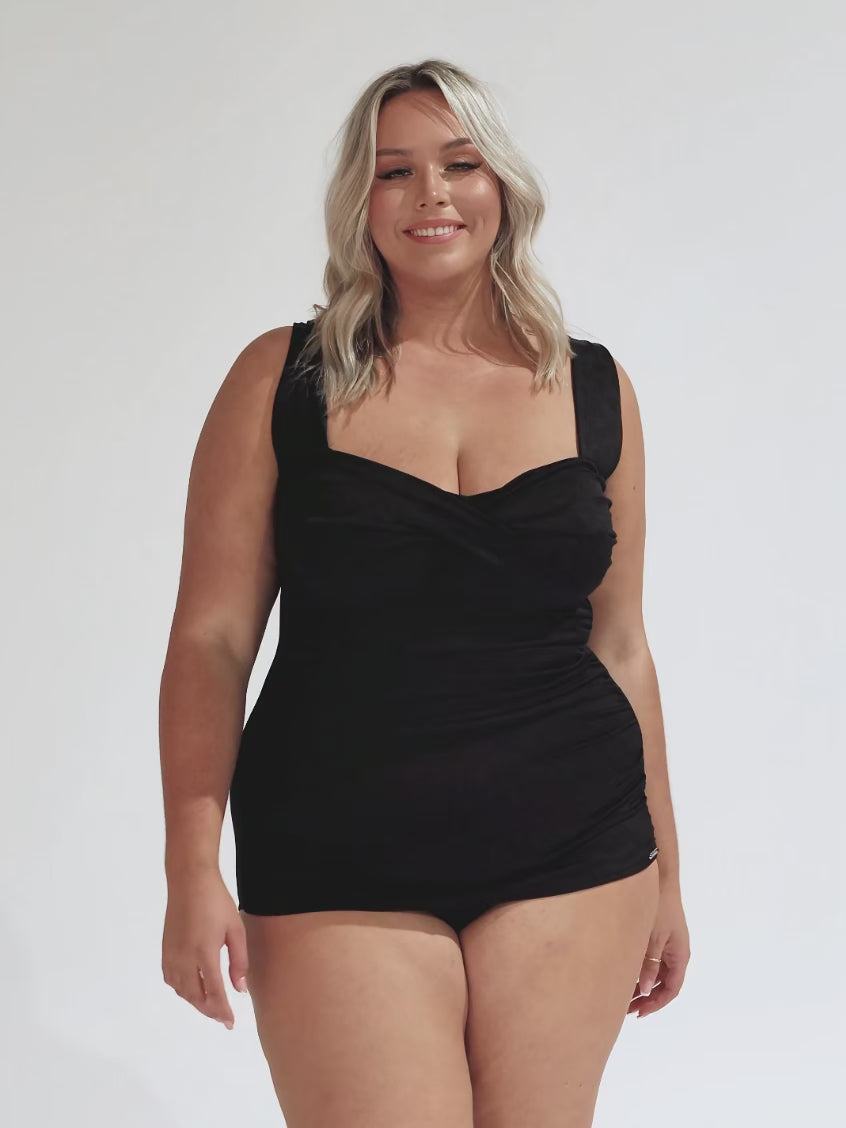 model wearing black textured retro skirted one piece