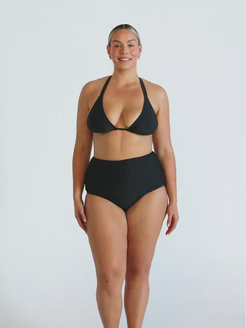 Blonde model in studio wearing a triangle halter bikini top