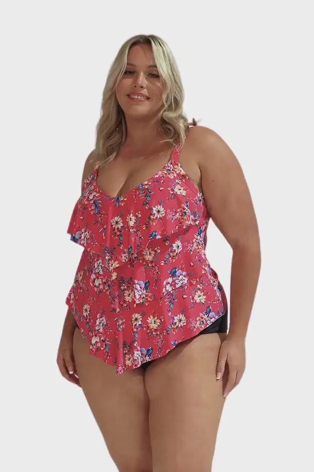 Model wearing hot pink floral three tier tankini top and black bottoms