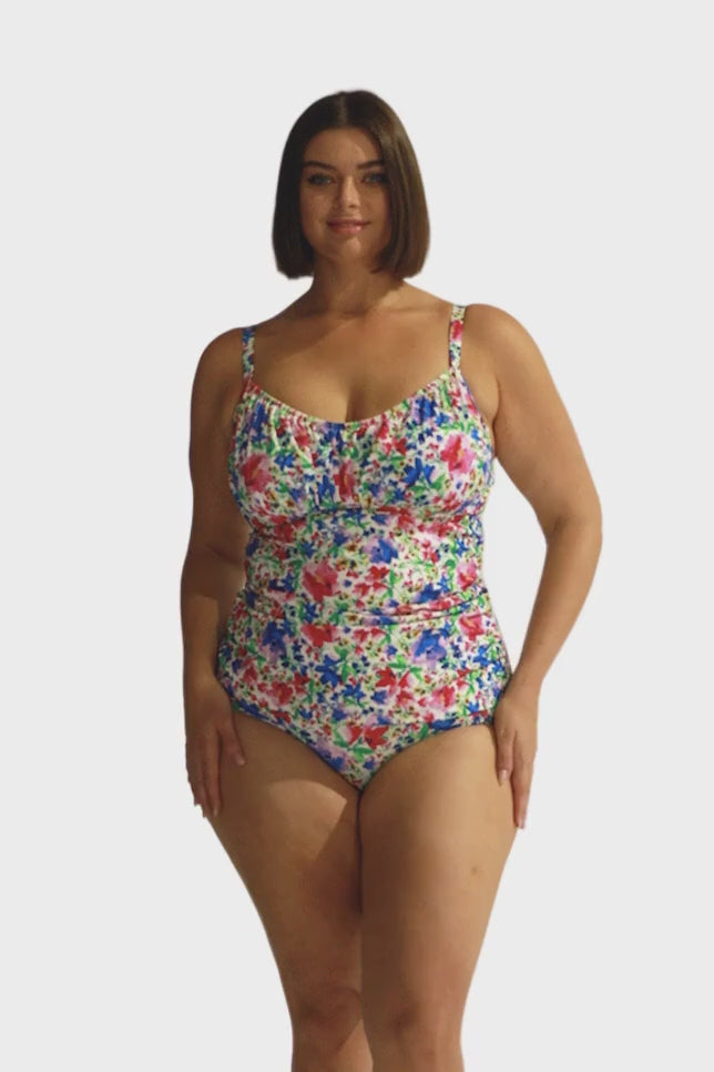 brunette model wears flattering ruched tankini top with underwire support and adjustable straps