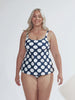 model wearing navy and large white polka dot tankini and matching swim bottoms
