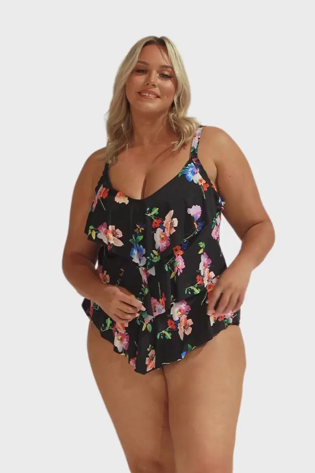 Model wearing black floral three tier tankini