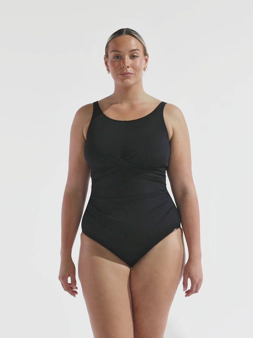 model wearing black high neck one piece
