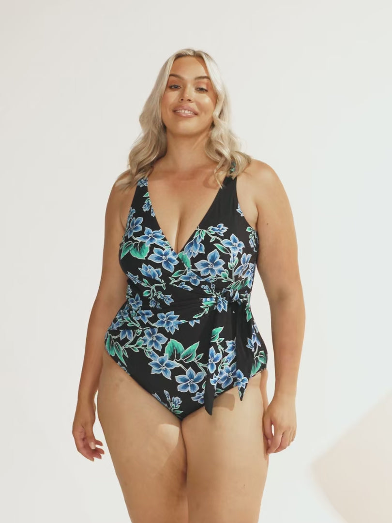 model wearing blue floral waist tie women's one piece