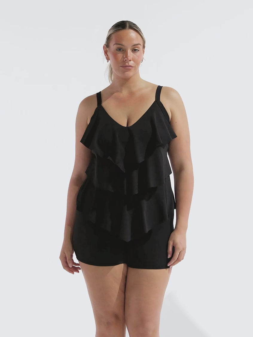 model wearing black chlorine resistant boyleg swim shorts with frilly tankini top