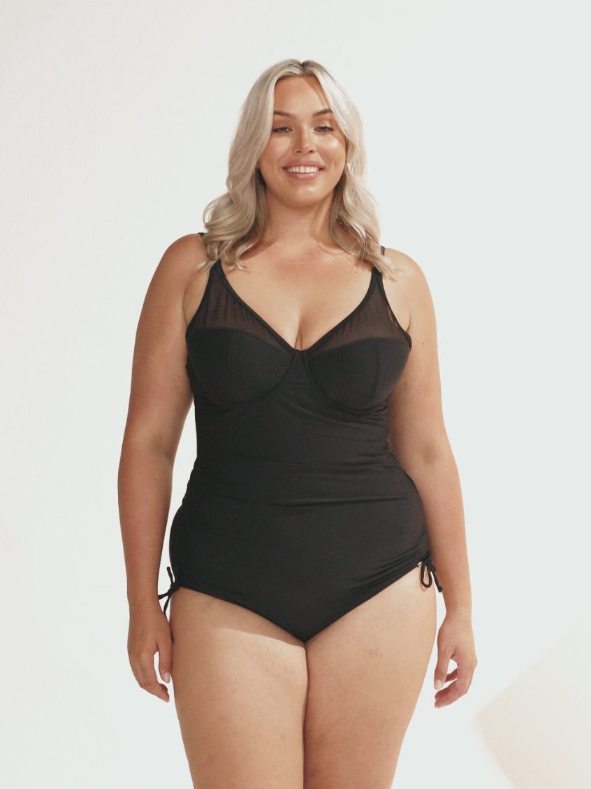 Blonde model in studio wearing ruched side one piece with mesh bust detail