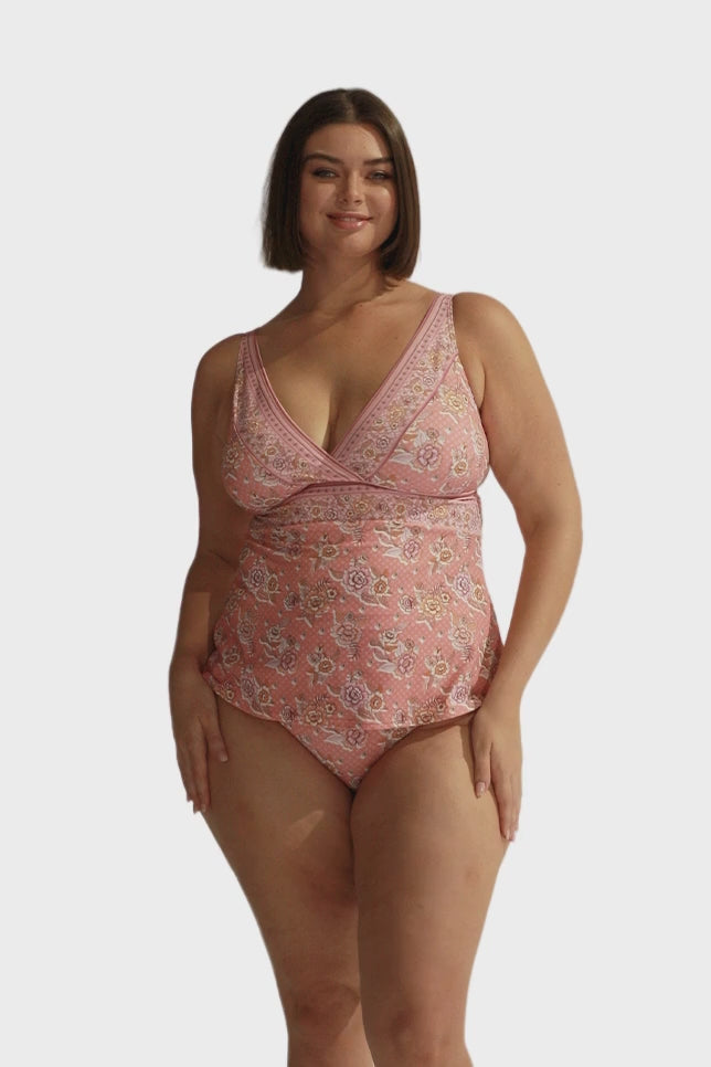 Brunette model wears pink floral v neck tankini top