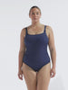 model wearing navy and white dots chlorine resistant women's one piece