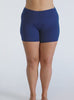 Model in studio wearing swim shorts in navy chlorine resistant