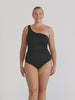 Video of model in studio wearing a one shoulder one piece with textured fabric