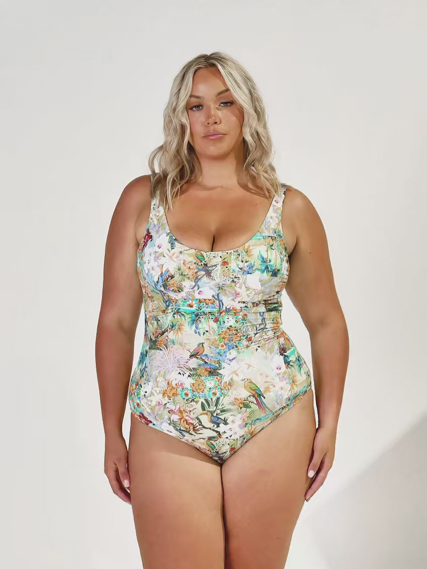 Model in studio wearing tank one piece wtih tropical print