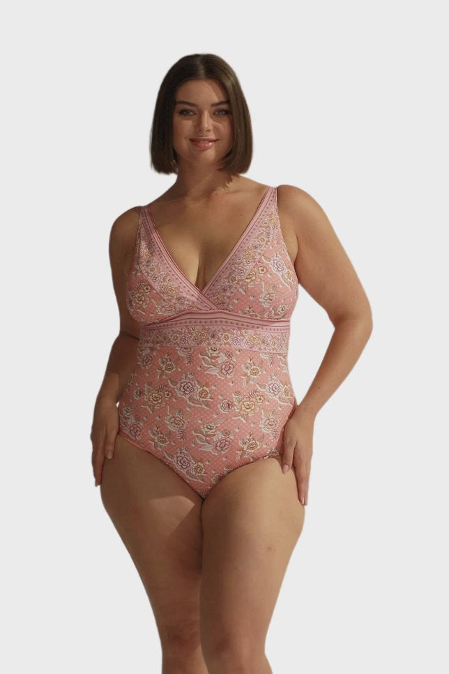 Brunette model wears pink floral womens v neck swimsuit