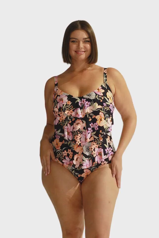 Brunette model wears black floral 3 tier ruffle one piece swimwear australia