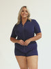 Model wearing navy short sleeve rash vest