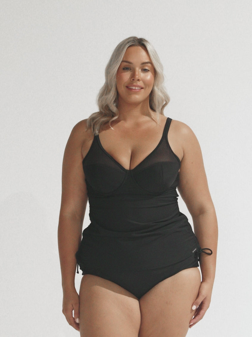 Blonde model in studio wearing ruched tankini top with mesh detail