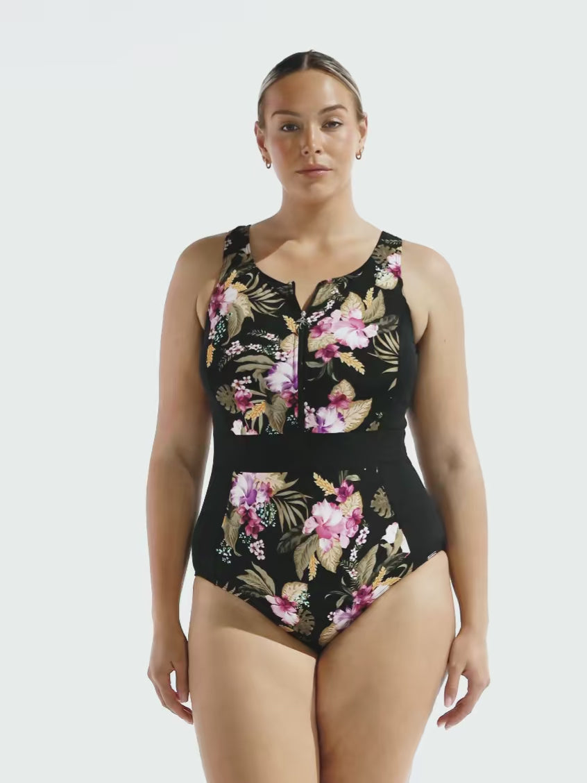 Blonde model in studio wearing a sleeveless one piece with zip front detail