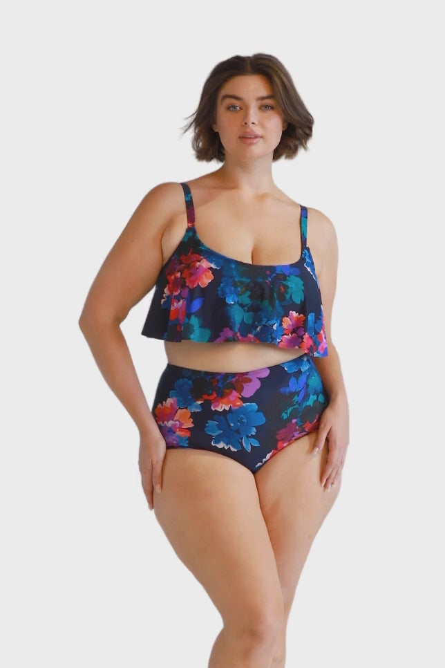 Brunette plus size women wears flattering navy floral high waisted bikini pant