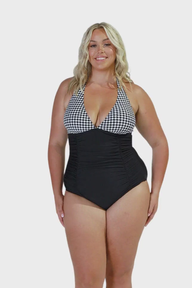 model wearing hounds tooth halter neck one piece