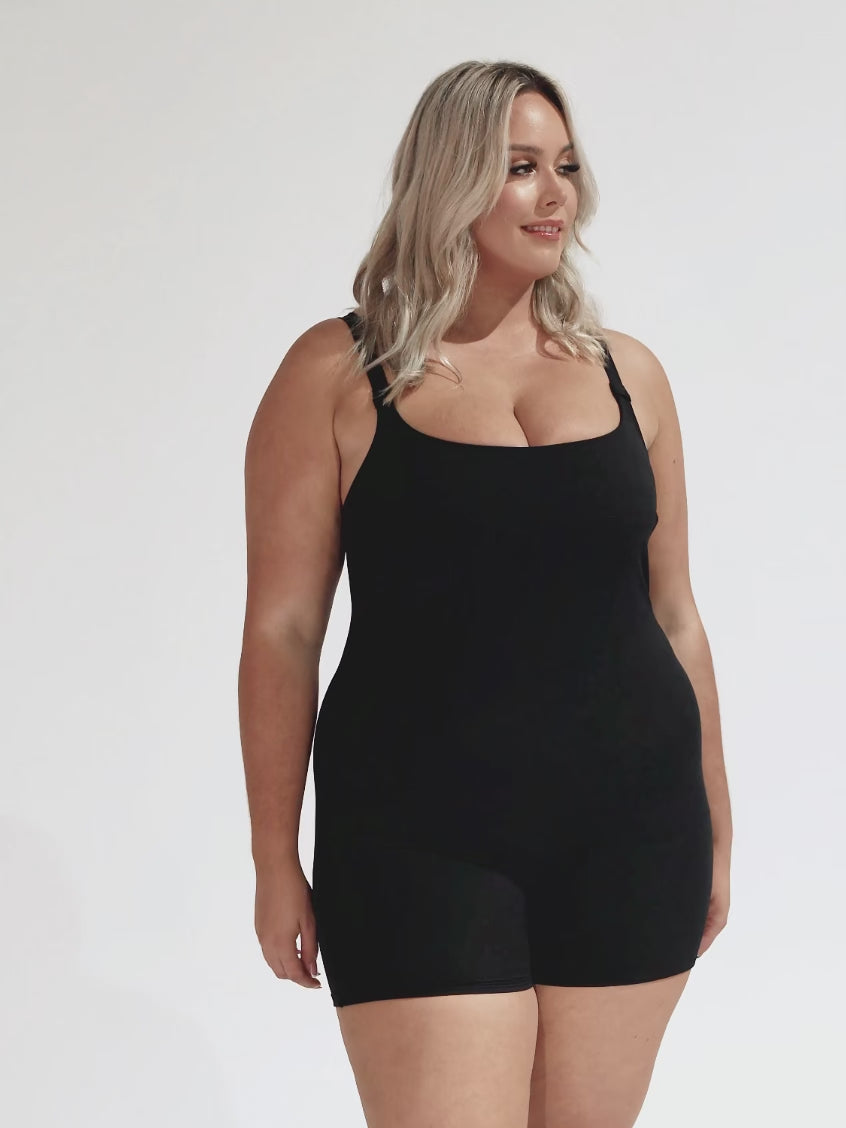 model wearing black boyleg one piece swimsuit