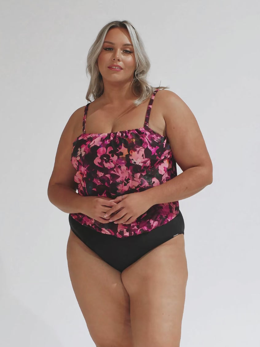 model wearing pink floral flouncy one piece