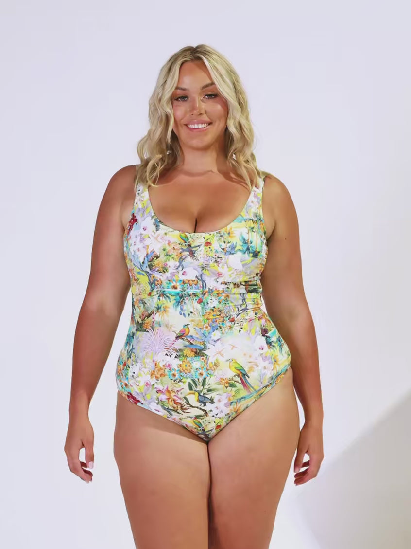 Blonde women in studio wearing a tank one piece in tropical print