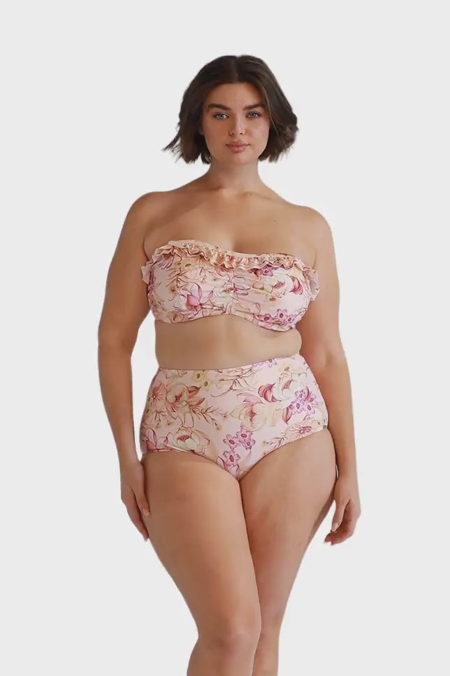 brunette model wearing blush pink floral high waisted swim bottoms