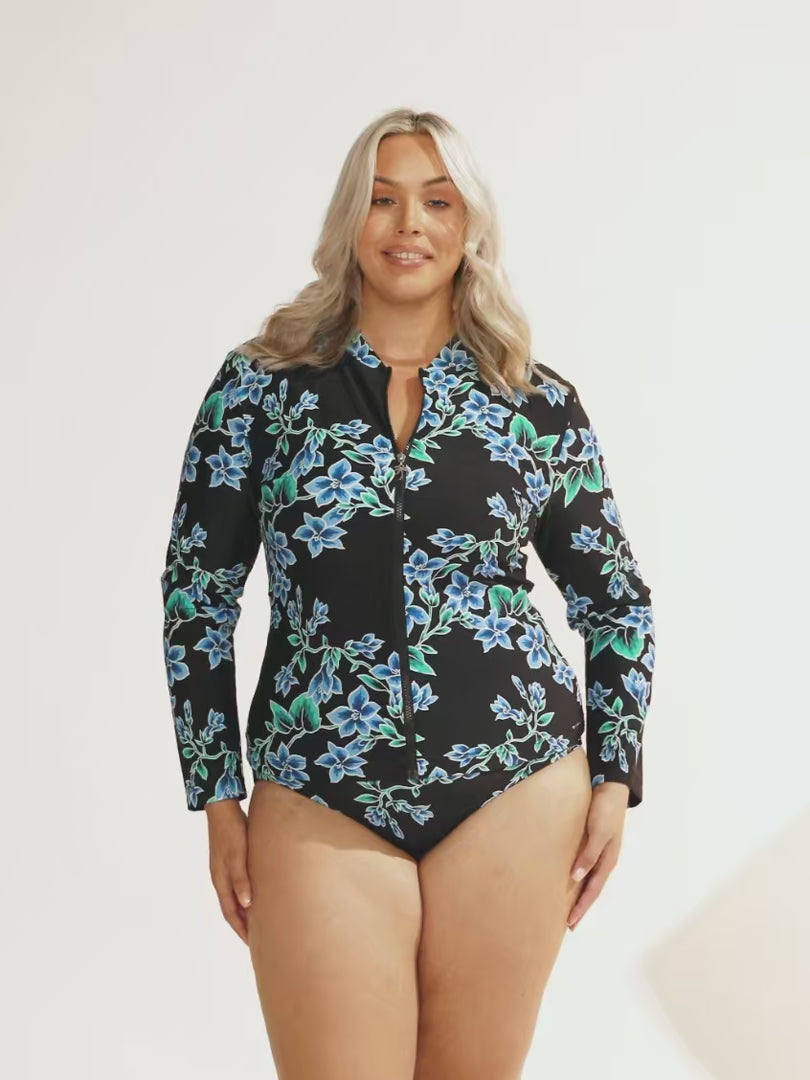 model wearing blue floral long sleeve zip front rash vest