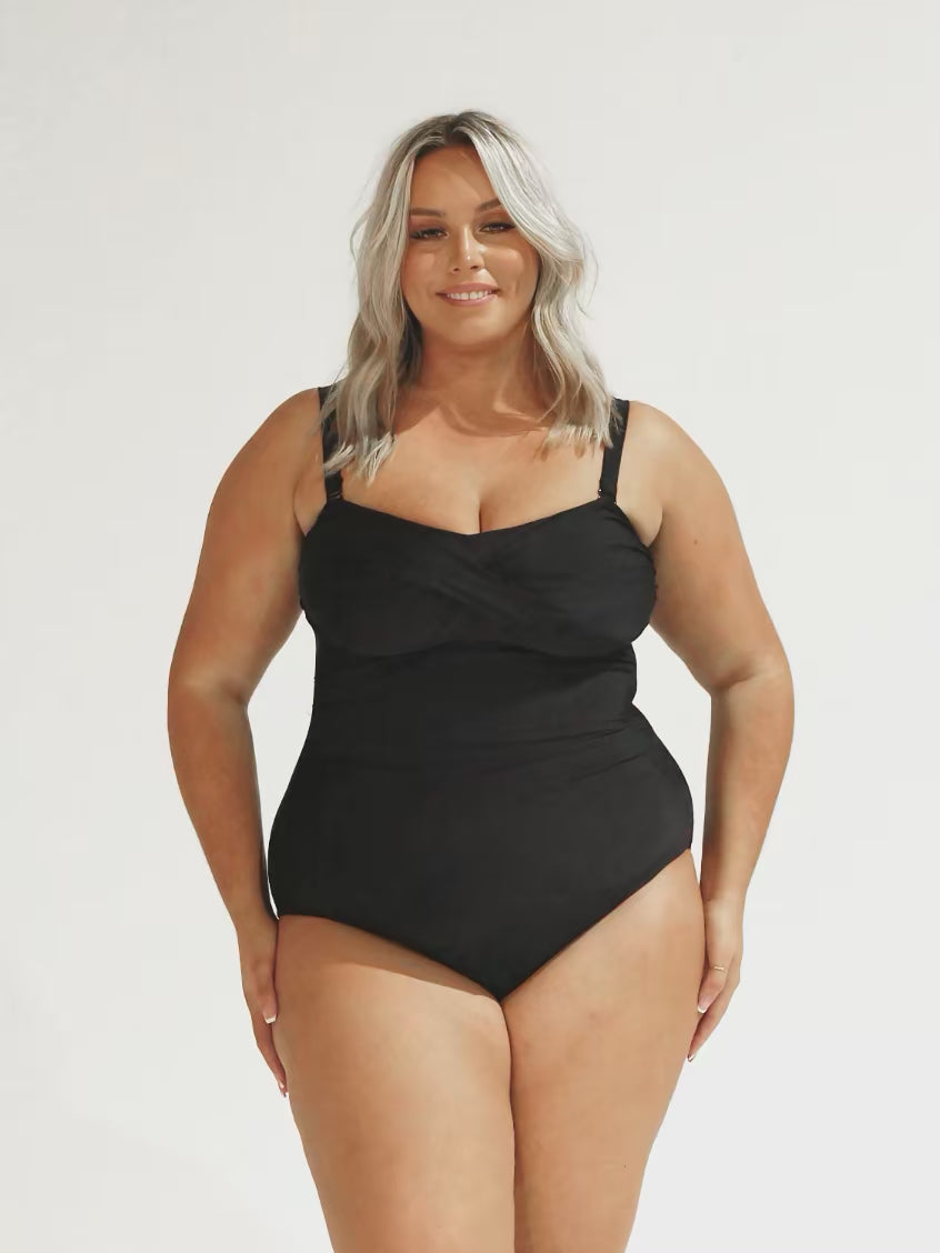 model wearing black twist bandeau one piece