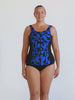 Blonde model in studio wearing sleeveless tankini top with full zip front