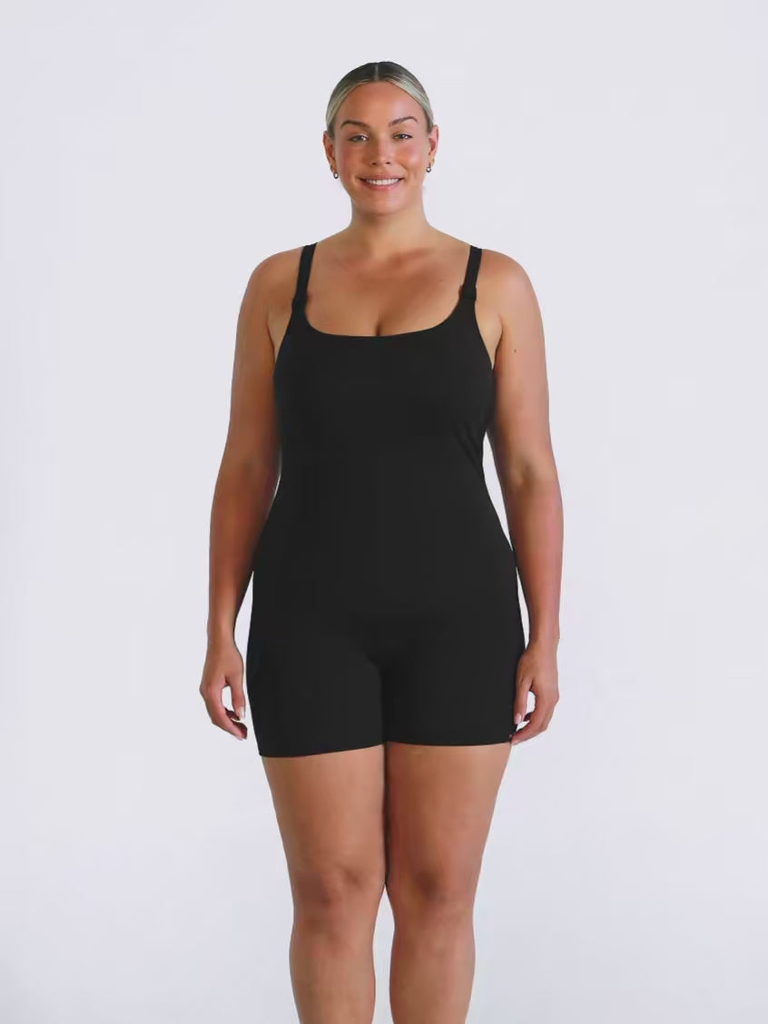 Blonde model in studio wearing a tank one piece boyleg in black chlorine resistant