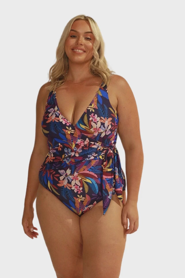 model wearing navy floral waist tie one piece